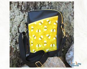 Cute crossbody travel bag with three pockets.  Bee print and Sun yellow lining.  Long strap and Goldtone hardware.